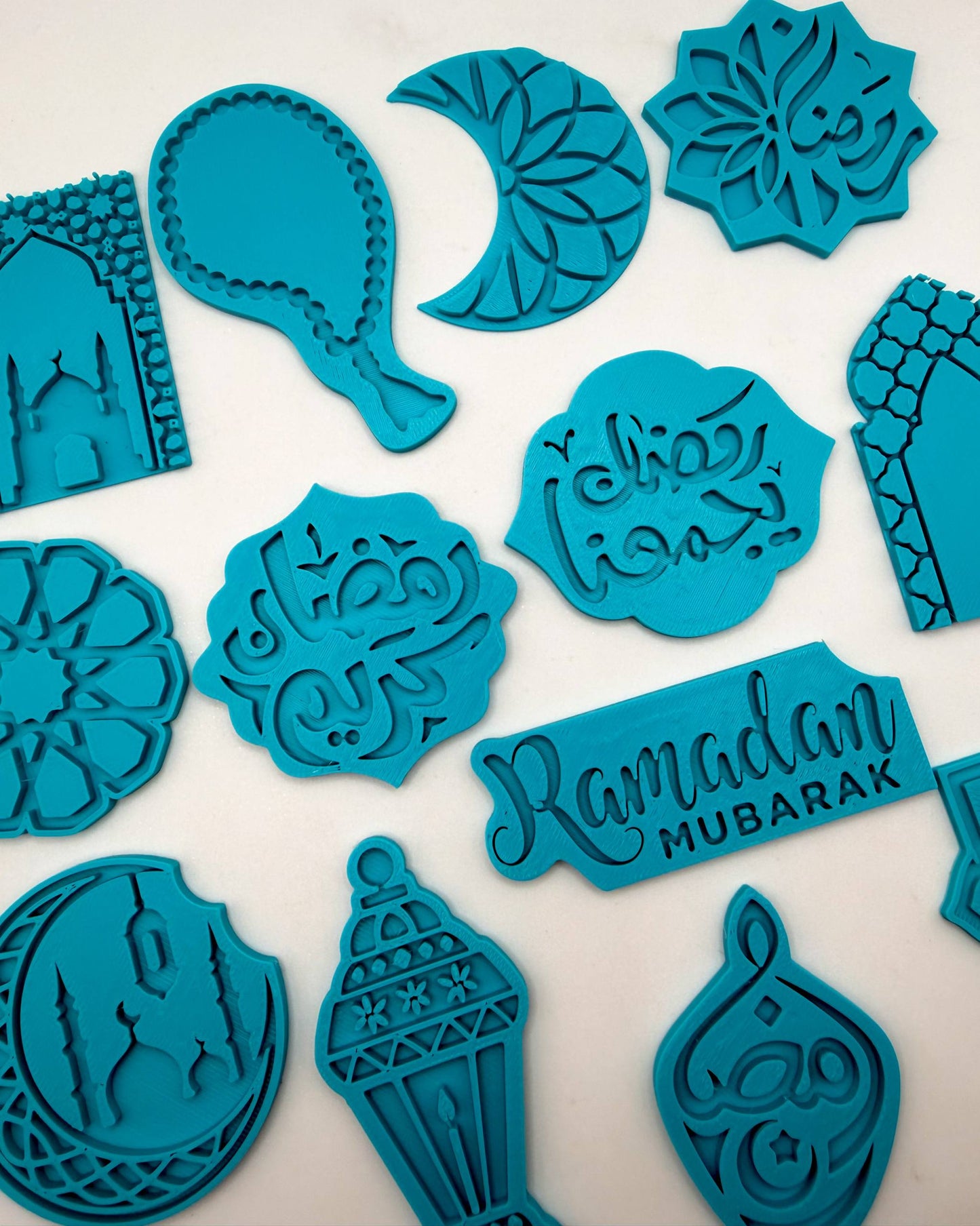 Collection of blue cookie cutters with Ramadan-themed designs on a white background